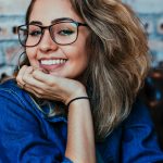 Closeup Photo of Smiling Woman Wearing Blue Denim Jacket